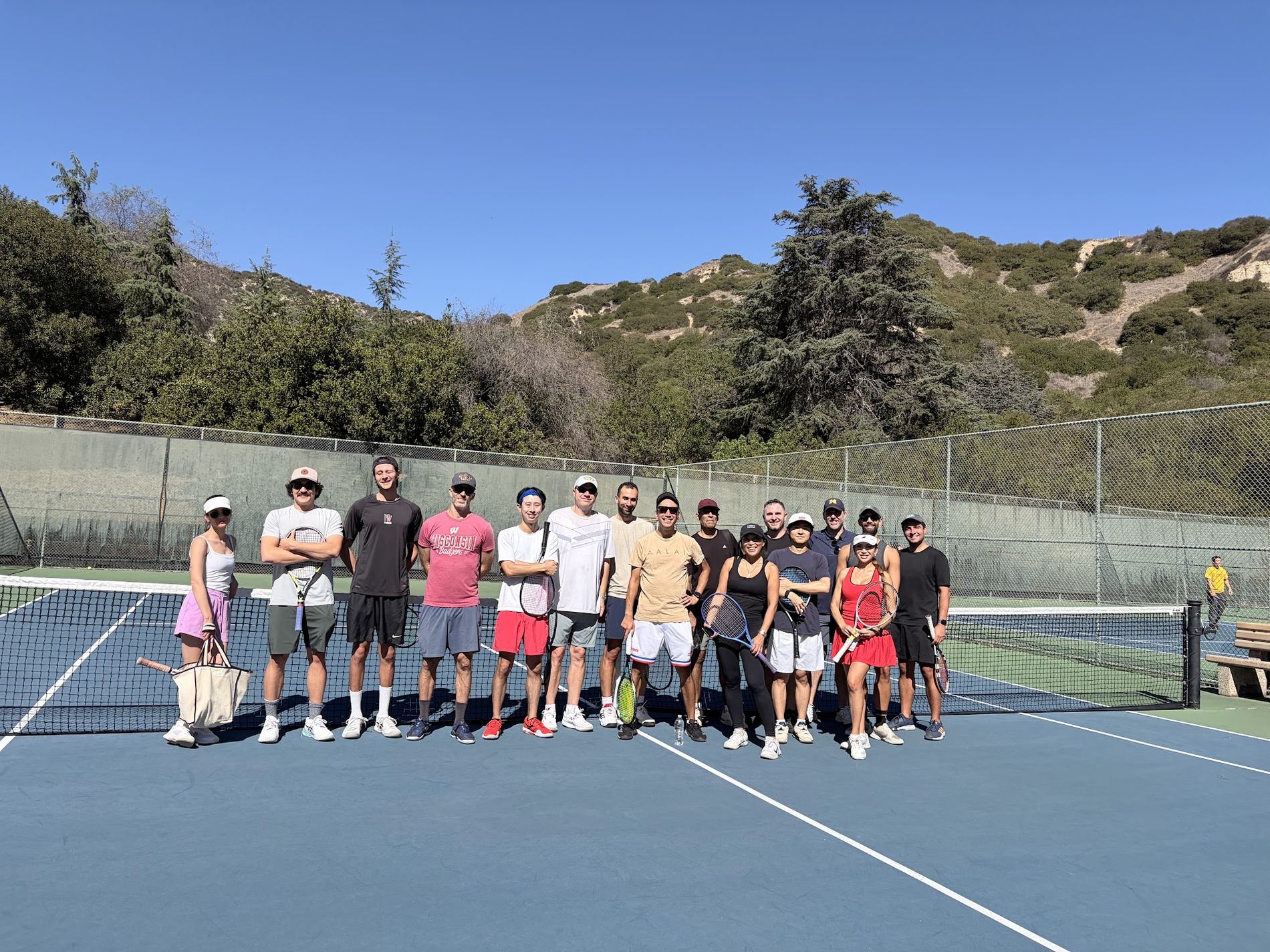 The full group lined up along the net at Vermont Canyon with the Griffith Park hills behind.